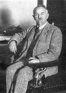 Black and white photograph of a seated man