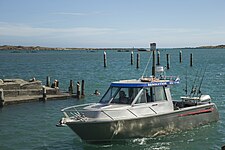 Whanganui River mouth, boat and swimmers