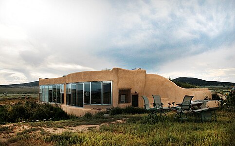 An exterior of a modern earthship