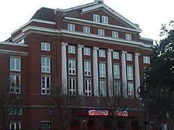 A four-story brick building in classical style with white trim.