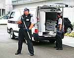 Security officers in Japan with a big baton.