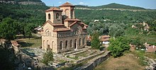 A rectangular church built of bricks with two towers