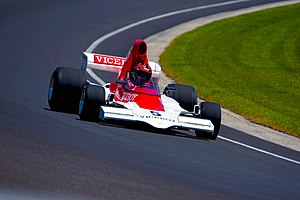 Lola T400 being driven at the Indianapolis Motor Speedway