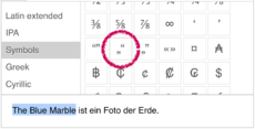 Captura de ecrã que mostra a ferramenta de inserção de caracteres especiais, com o texto selecionado, e o carácter especial que será inserido.