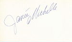 The handwritten name "Janée Michelle" in grey slanted from the bottom left to the top right all on a white background with the "M" curled under the first name