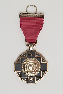 Pictorial depiction of Padma Vibhushan medal in golden colour with its pink ribbon