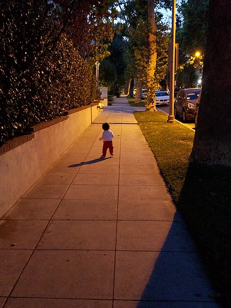 File:Young Child Walking on a Street.jpg