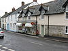 Street scene, showing shops and houses including a post office.