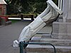 A marble statue fallen off its plinth