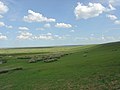 Een landschap kan als achtergrond dienen. Deze afbeelding lijkt een beetje op de standaardachtergrond van Windows XP.