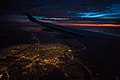 left wing over night city