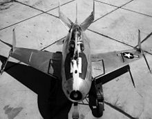 Black-and-white top view of potato-shaped aircraft, with a hook extended over top of canopy