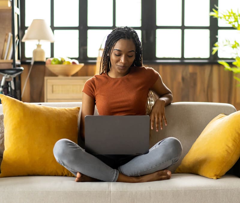 An image of a woman learning how to remove malware from her laptop.