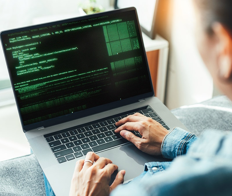 Man looking at his computer as he learns about malware.