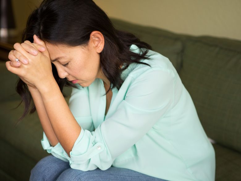 A suffering Christian woman in prayer