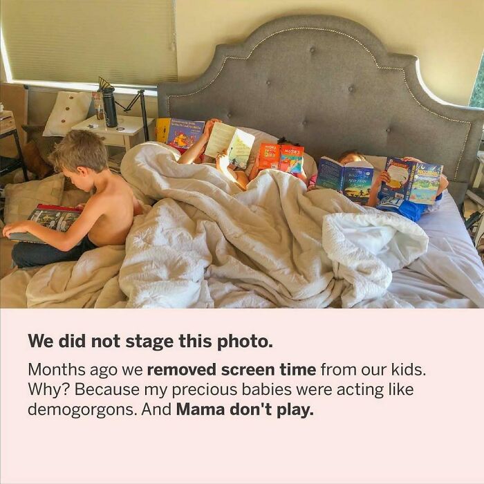 Children lying in bed reading books, surrounded by pillows and blankets, illustrating everyday family life.