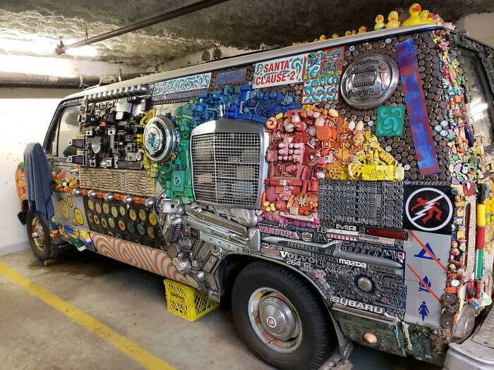 Van covered in eclectic decorations and trinkets, demonstrating a creative example of car-fails in a parking garage.