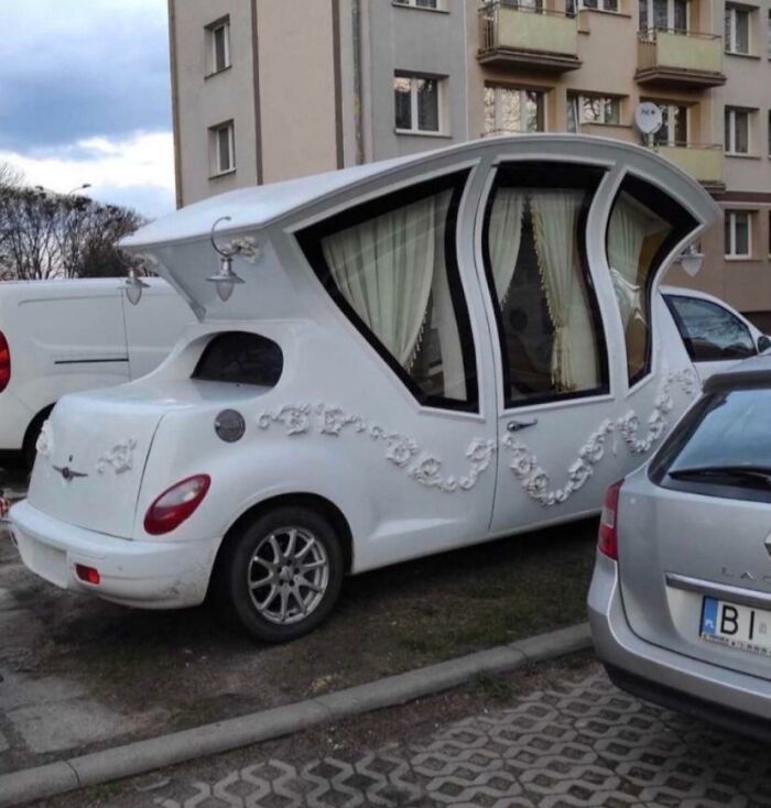 Unusual car design with ornate decorations, embodying a classic example of car-fails in an urban setting.