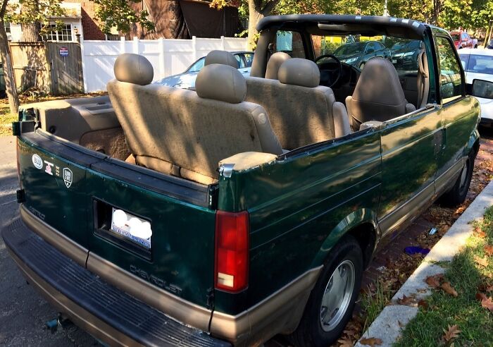 Convertible van with seats exposed, showcasing a unique Car-Fails modification on a sunny day.