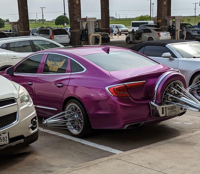 Purple car with exaggerated spiked rims and custom design, highlighting a unique example of car-fails.