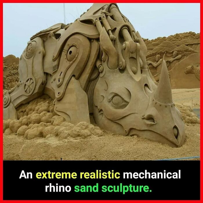 Realistic mechanical rhino sand sculpture in a detailed design, showcasing impressive artistry.