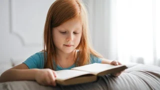 School child reading book