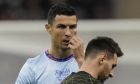 Cristiano Ronaldo gestures playing for a combined XI of Saudi Arabian teams Al Nassr and Al Hilal is flanked by PSG's Lionel Messi during a friendly soccer match, at the King Saud University Stadium, in Riyadh, Saudi Arabia, Thursday, Jan. 19, 2023. (AP Photo/Hussein Malla)