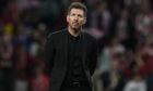 Atletico Madrid's head coach Diego Simeone walks after the group B Champions League soccer match between Atletico Madrid and Bayer 04 Leverkusen at the Civitas Metropolitano stadium in Madrid, Spain, Wednesday, Oct. 26, 2022. (AP Photo/Manu Fernaandez)