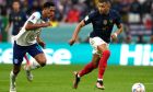 England's Jude Bellingham, left, and France's Kylian Mbappe challenge for the ball during the World Cup quarterfinal soccer match between England and France, at the Al Bayt Stadium in Al Khor, Qatar, Saturday, Dec. 10, 2022. (AP Photo/Frank Augstein)