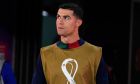 Portugal's Cristiano Ronaldo walks to his team bench at the beginning of the World Cup quarterfinal soccer match between Morocco and Portugal, at Al Thumama Stadium in Doha, Qatar, Saturday, Dec. 10, 2022. (AP Photo/Petr David Josek)