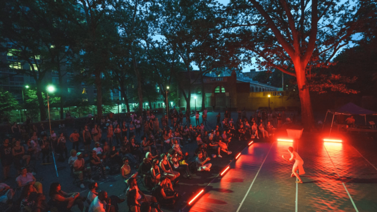 Outdoor festical with guests watching a performer