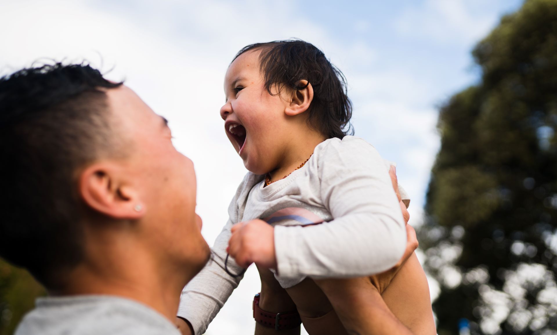 Image of child being held up in the air