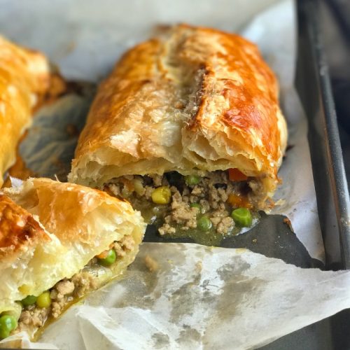 Turkey Curry Puff sliced showing the velvety Indian curry and sauce.