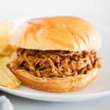 BBQ pulled pork sandwich on white plate