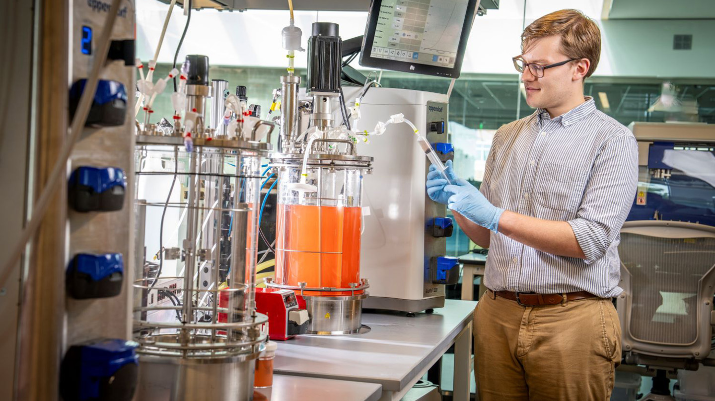 Will Stone, a molecular biologist, experiments in the biomanufacturing lab (Credit: Johns Hopkins APL/Craig Weiman)