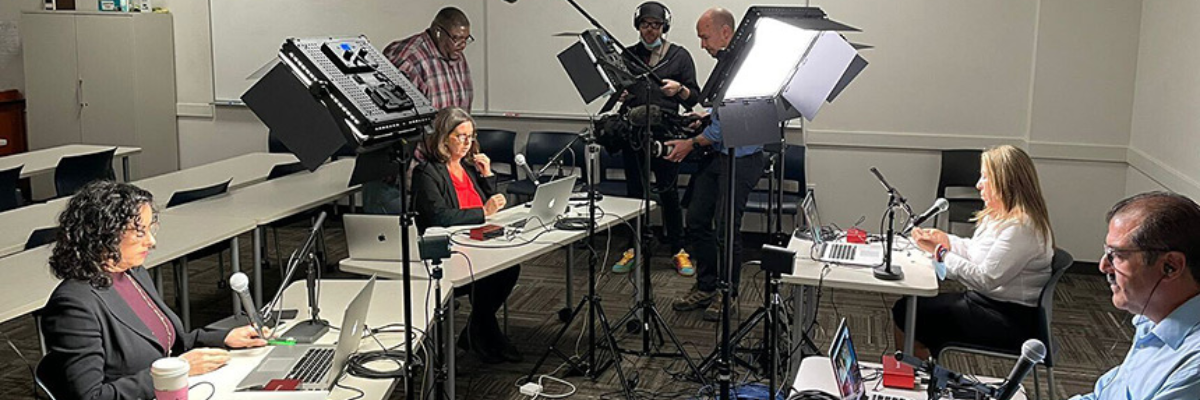 People in a room getting ready to record a hearing