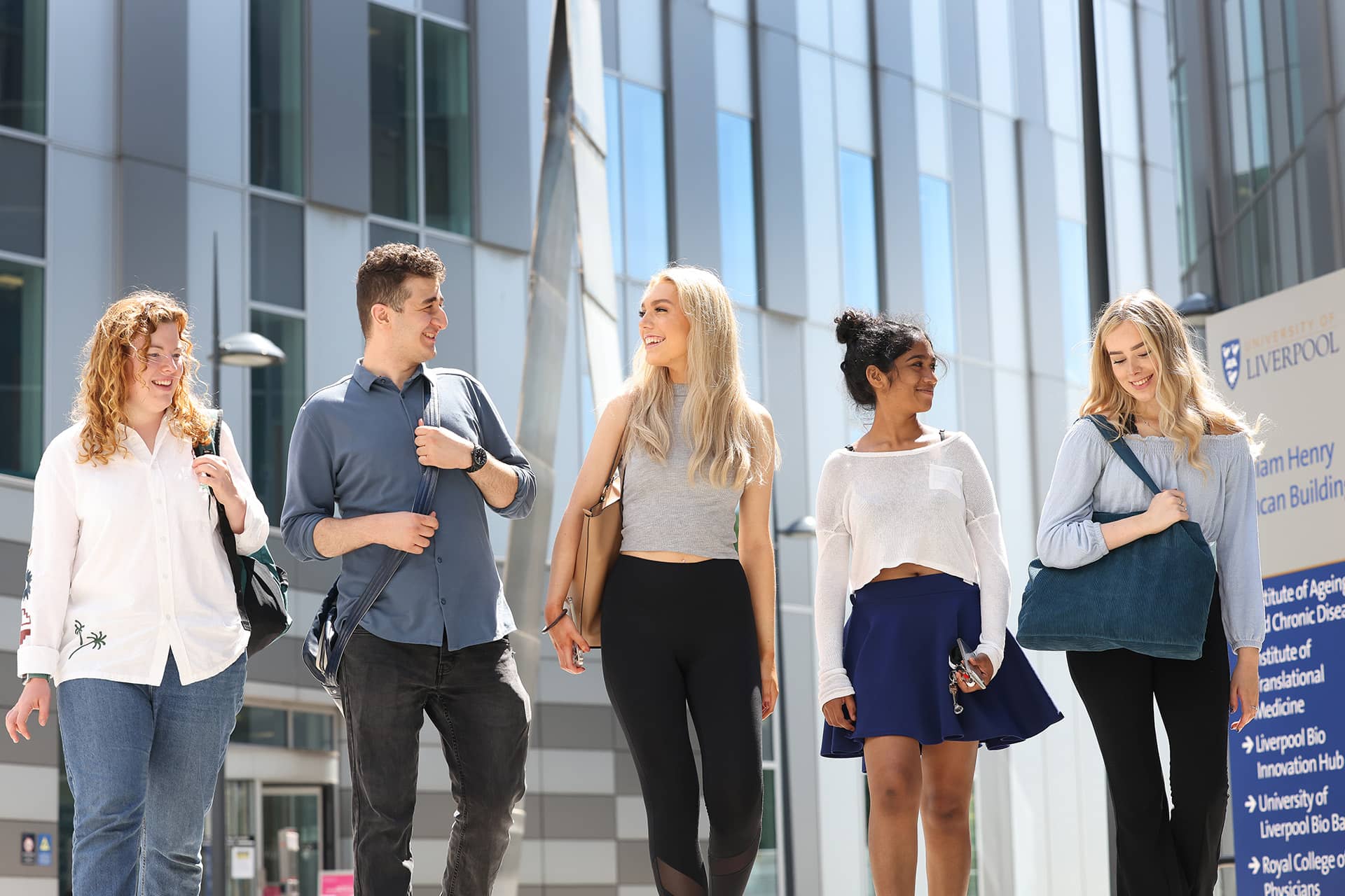 Group of students walking in front of University buildings