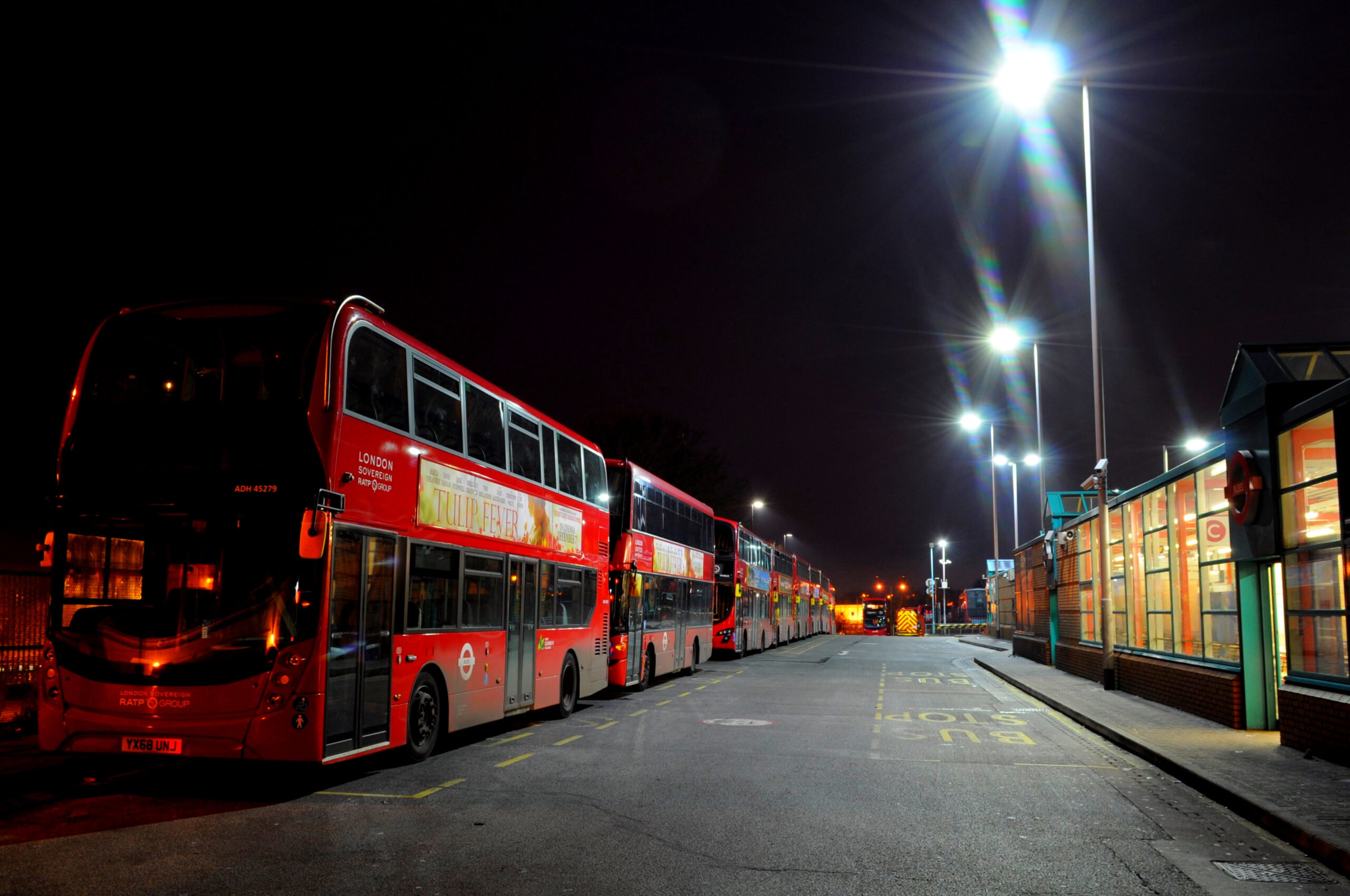 A bus stop in London at night