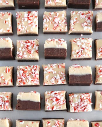 Top down view of many pieces of peppermint bark fudge with several turned on their sides.