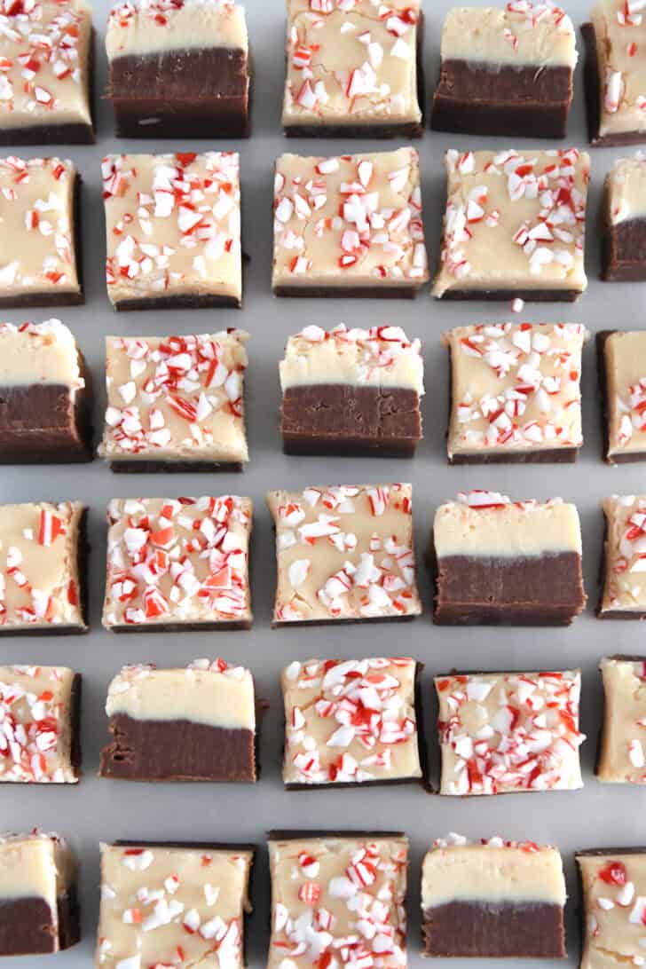 Top down view of many pieces of peppermint bark fudge with several turned on their sides.