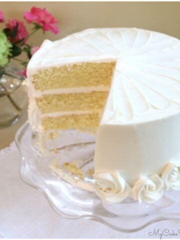 Sliced Vanilla Buttermilk Cake on a glass pedestal.