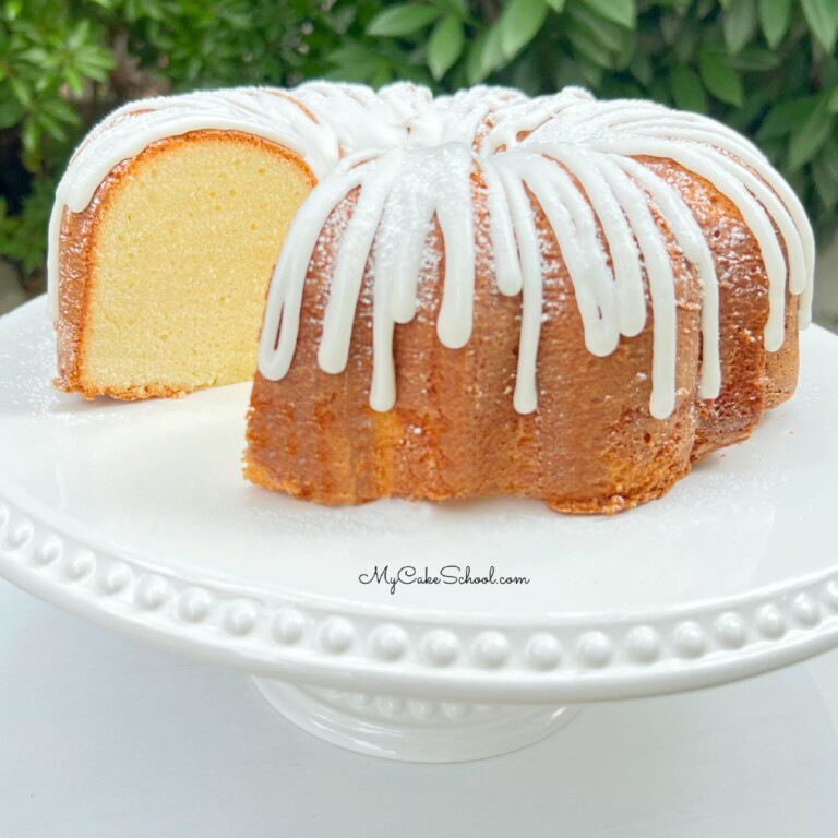 Sliced Cream Cheese Pound Cake on white pedestal.