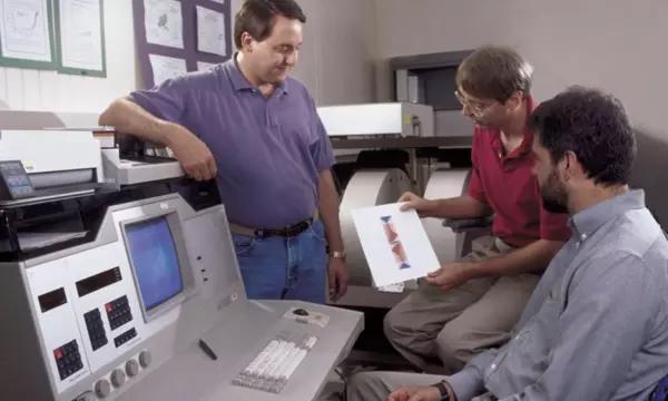 Donald Porter (left) and Michael Donahue (center) discuss a micromagnetic simulation with NIST physicist Robert McMichael.  Photo credit: NIST 