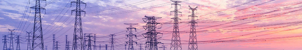 Setting sun background of purples and pinks with power towers and lines