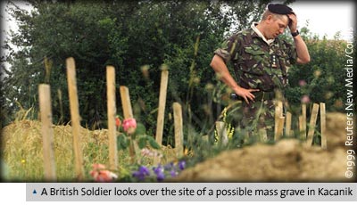 A British Soldier looks over the site of a possible mass grave in Kacanik