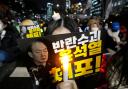 A participant holds a banner with writing reading ‘Arrest the rebellion leader Yoon Suk Yeol’, during a rally to demand South Korean President Yoon Suk Yeol’s impeachment outside the National Assembly in Seoul (Ahn Young-joon/AP)