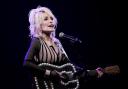 FILE – Dolly Parton performs during an event celebrating the Kansas statewide expansion of Dolly Parton’s Imagination Library in 2023 (AP Photo/Charlie Riedel, File)