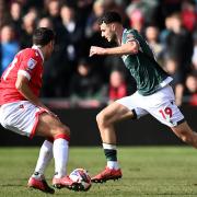 Bolton Wanderers' Aaron Collins competes with Wrexham's Matty James