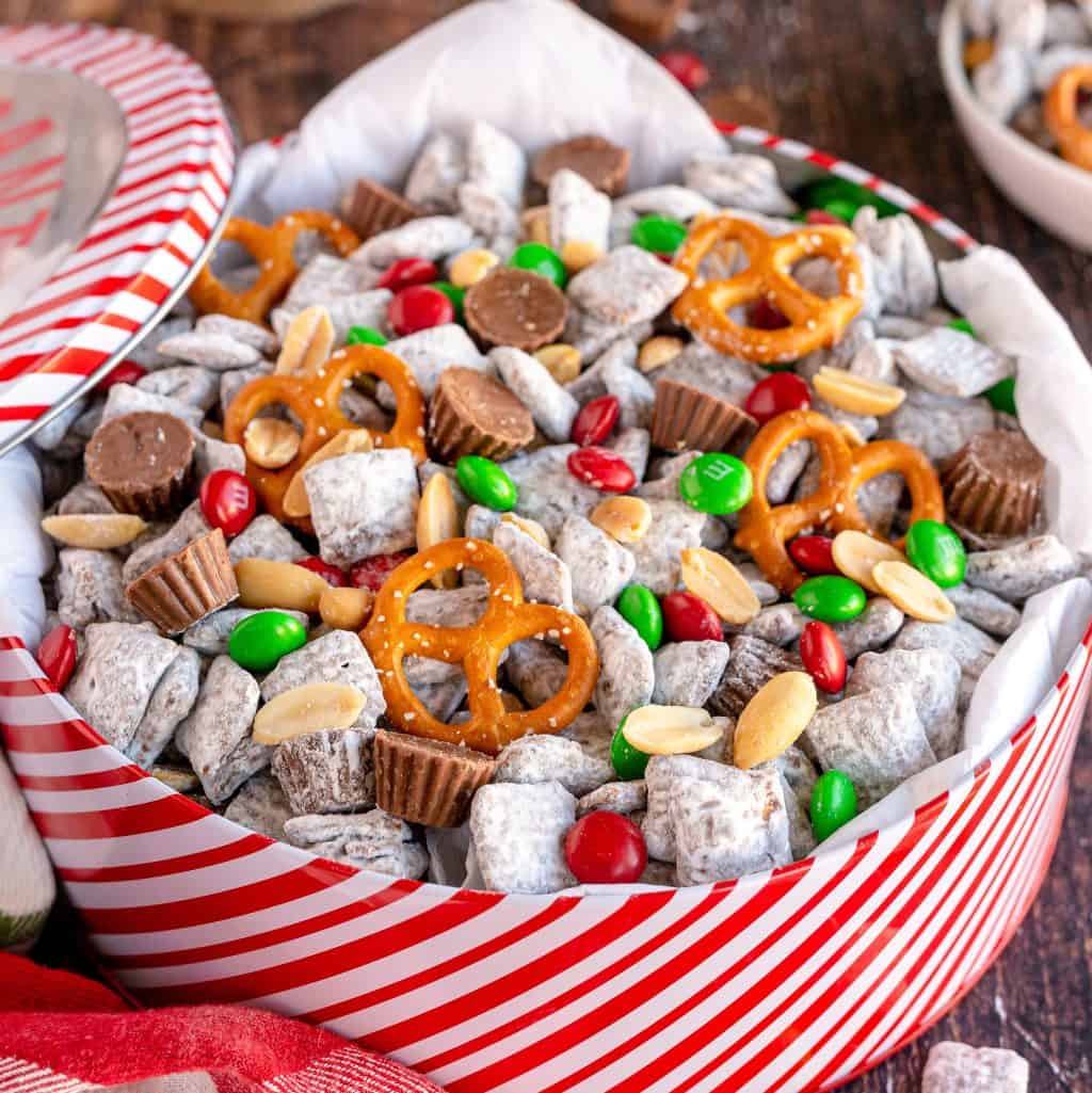 Square image close up of Reindeer Chow in gift box tin.