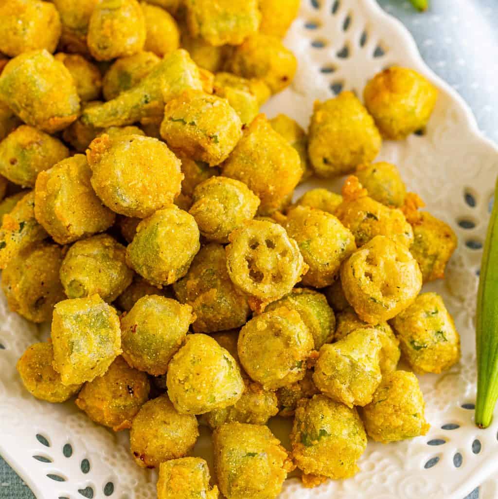 Square image of Fried Okra on white platter overhead.